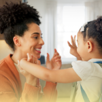 Mãe se despede da filha antes de ir para a escola, demonstrando carinho, atenção e envolvimento na vida escolar da criança.