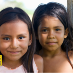 Crianças indígenas sorrindo em comunidade, representando diversidade cultural e identidade no dia dos povos indígenas no Brasil